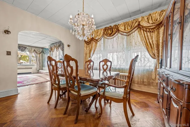 a view of a dining room with furniture wooden floor and chandelier