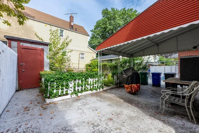 a view of a backyard with sitting area