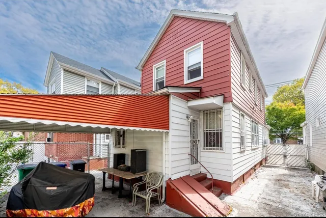 a view of house with outdoor seating area