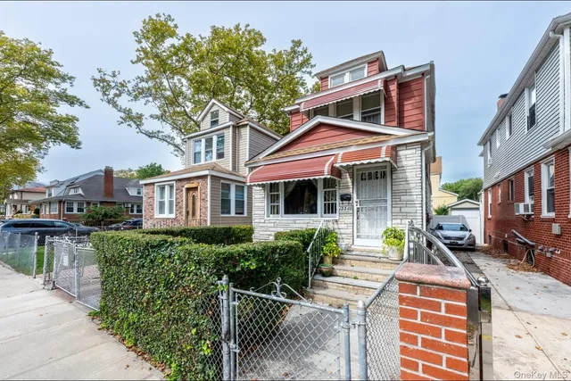 a front view of a house with a garden