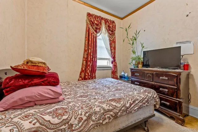 a bedroom with a bed and a flat screen tv