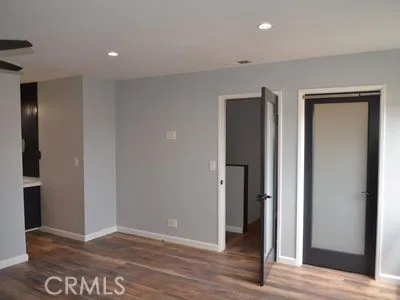 a view of hallway with wooden floor