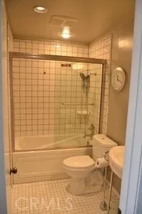 a bathroom with a toilet and shower
