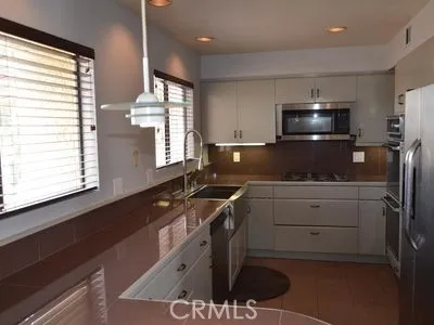 a kitchen that has a sink and a stove