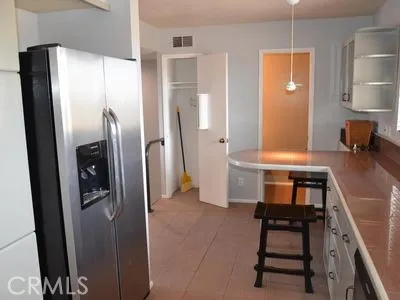 a kitchen with stainless steel appliances granite countertop a refrigerator and a stove