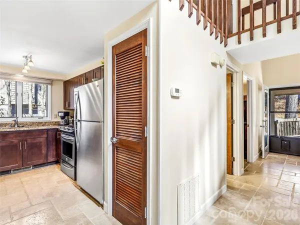 a kitchen with stainless steel appliances granite countertop a refrigerator and a sink