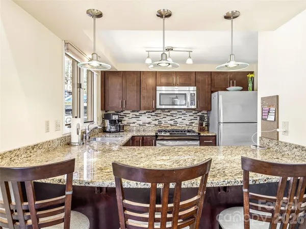 a view of a kitchen area kitchen island dining table and chairs
