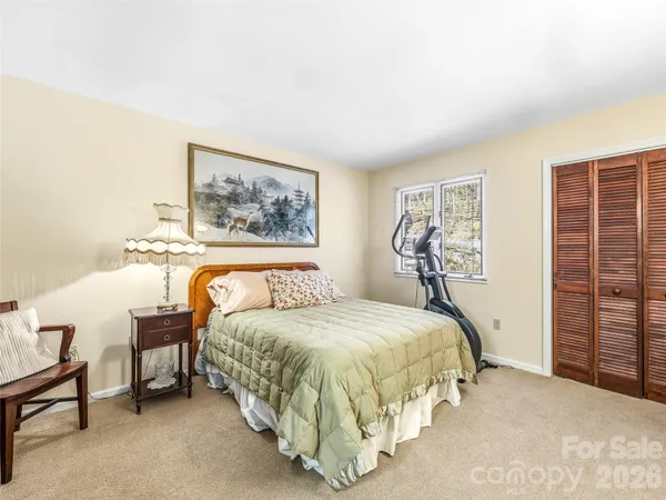 a bedroom with a bed and a table in it