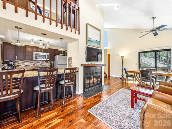 a living room with fireplace furniture and a wooden floor