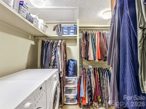 a view of walk in closet with clothes