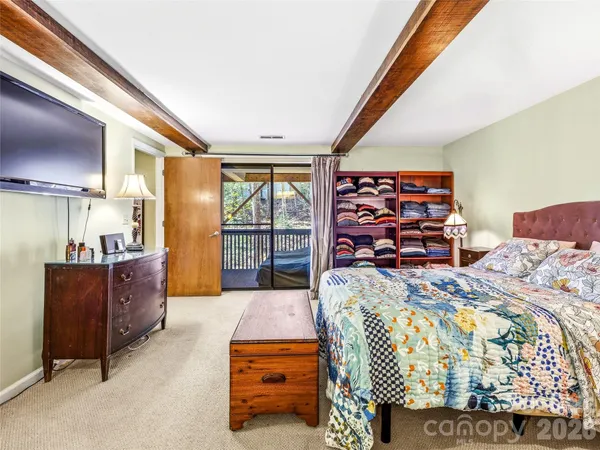 a bed room with a bed and a television