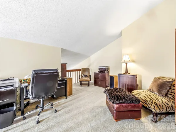 a living room with furniture a couch and a flat screen tv