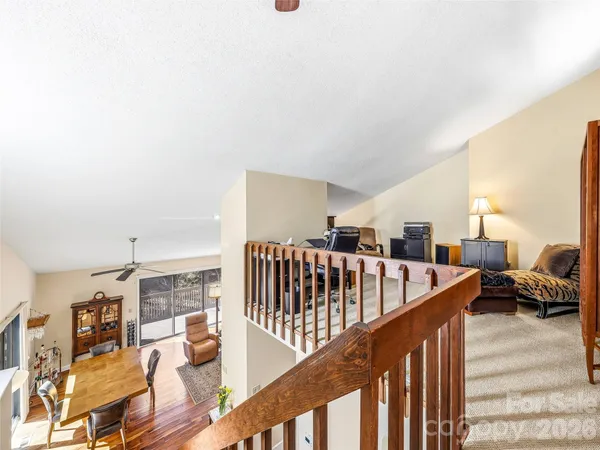 a living room with furniture and stairs