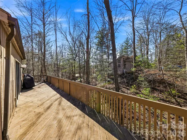 a view of balcony with wooden floor and fence