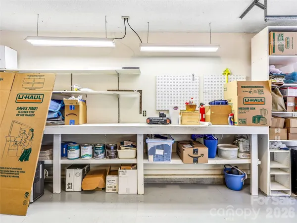 a kitchen with stainless steel appliances granite countertop a lot of cabinets and wooden floor