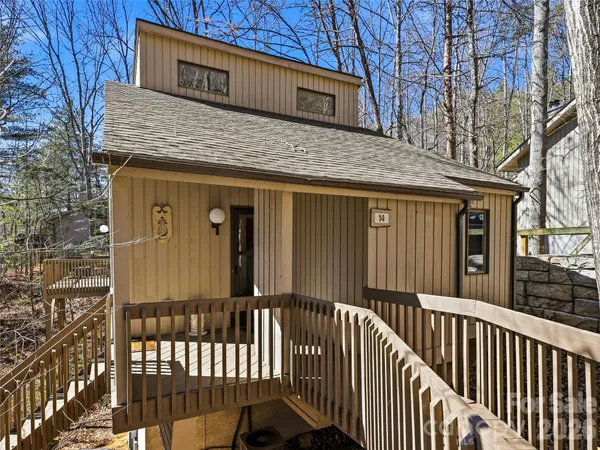 a view of a house with a wooden fence