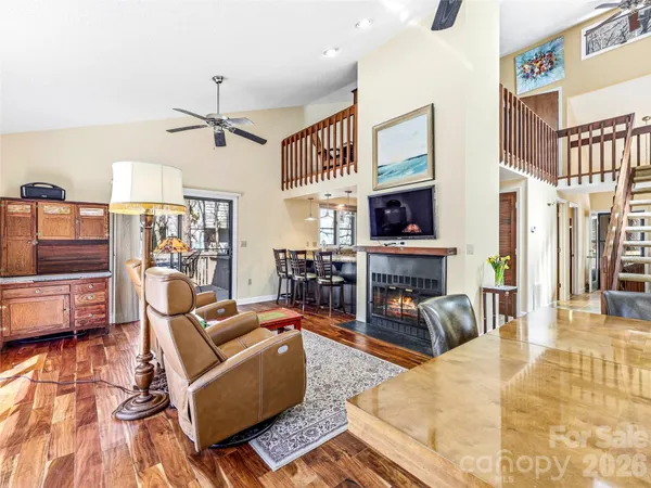 a living room with furniture a fireplace and a flat screen tv