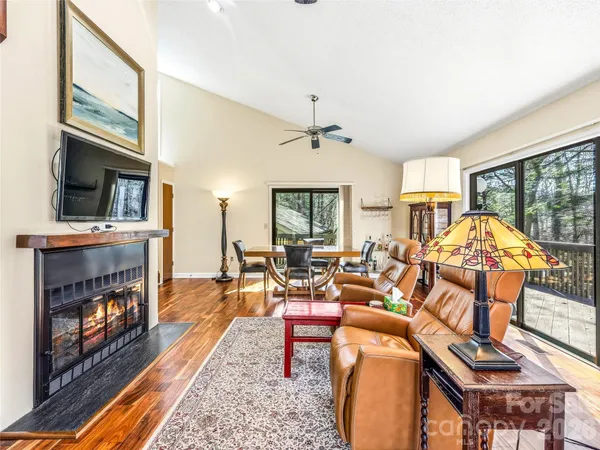 a living room with furniture fireplace and flat screen tv