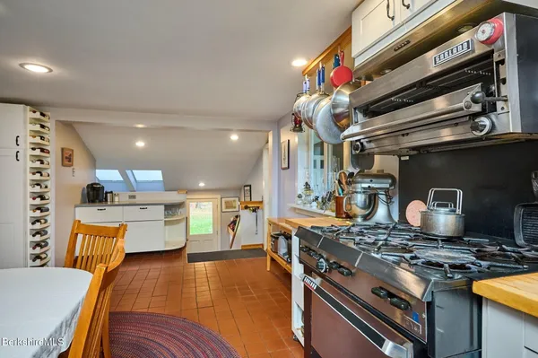 a kitchen with stainless steel appliances granite countertop a stove and a refrigerator