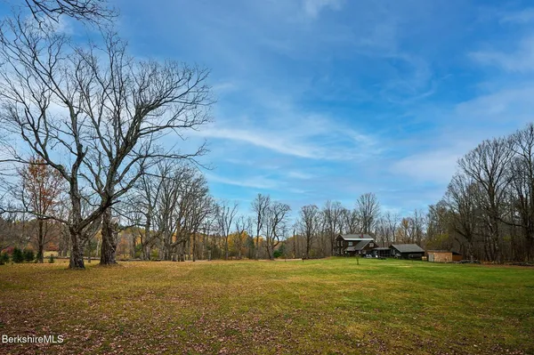 a view of a field with trees around