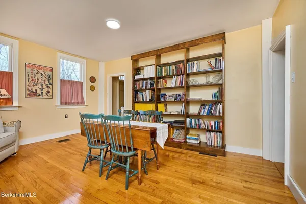 a view of a workspace room with furniture and wooden floor