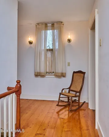 a view of a livingroom with chair and a window