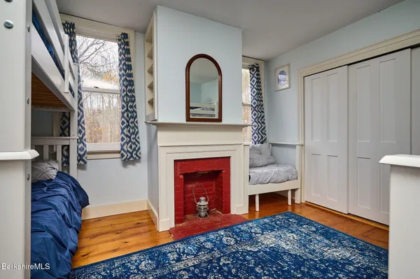 a view of a livingroom with a fireplace and glass door