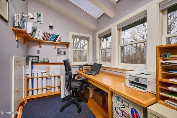 a room with furniture a flat screen tv and a window