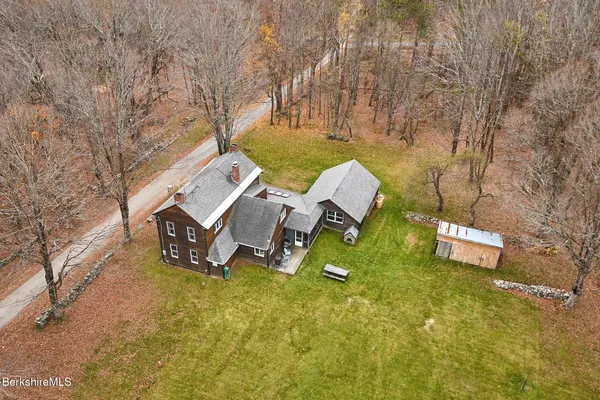 a backyard of a house with outdoor seating and trees