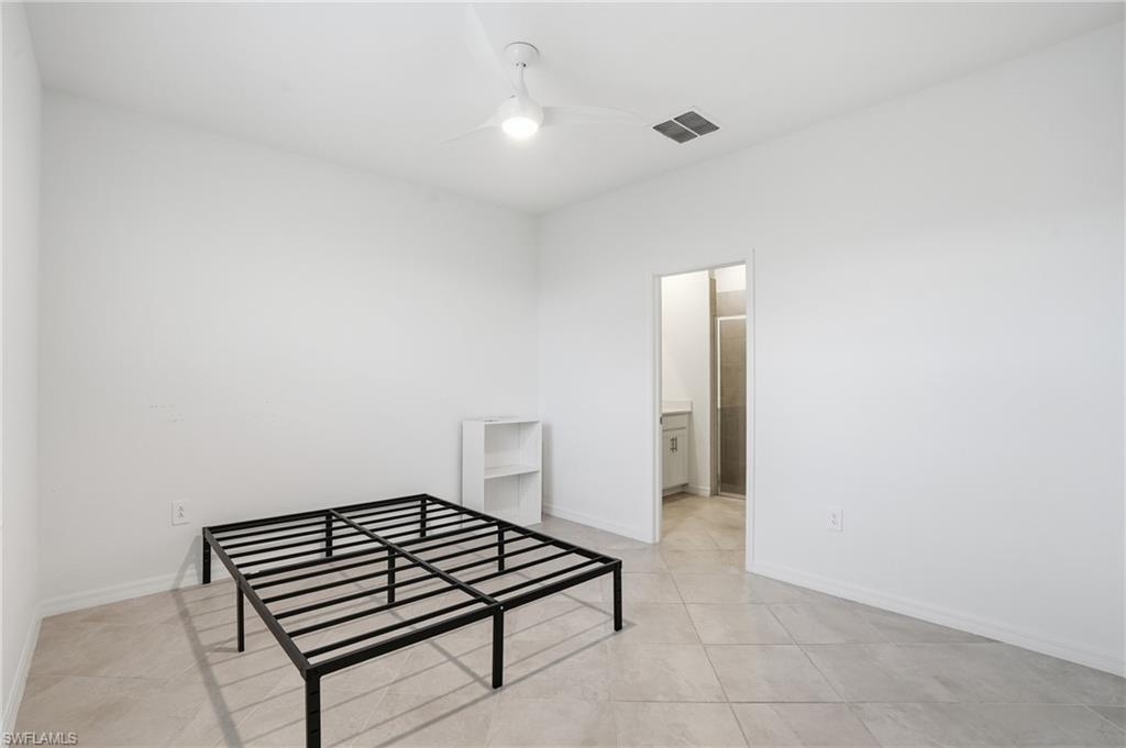 2215 Dragonfruit Way Naples, FL 34120 - Photo 22 of 38 a view of a livingroom with wooden floor and white walls
