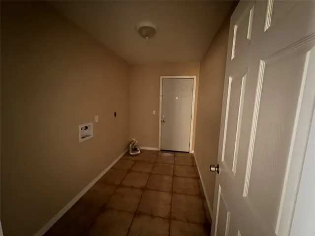 a view of an empty room and a window