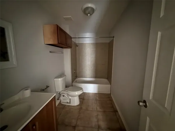 a view of an empty room and a window
