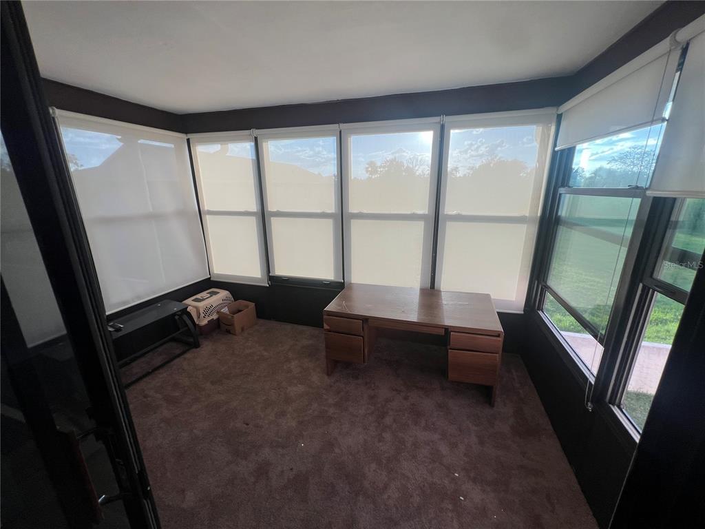9980 Eagles Point Circle, Unit 3 Port Richey, FL 34668 - Photo 11 of 23 a living room with furniture and a large window