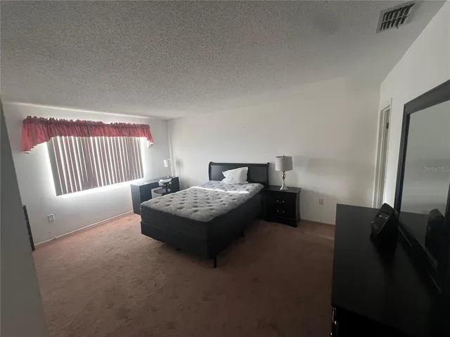 a bedroom with a bed and a mirror