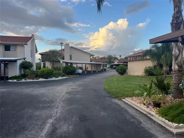 a view of a house with a yard and a street