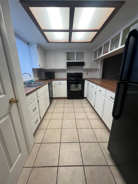 9980 Eagles Point Circle, Unit 3 Port Richey, FL 34668 - Photo 5 of 23 a kitchen with stainless steel appliances cabinets a sink and a stove top oven