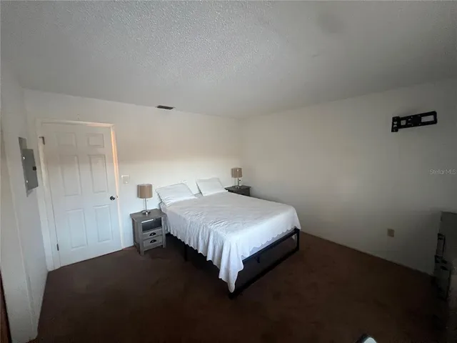 a bedroom with a bed and dresser