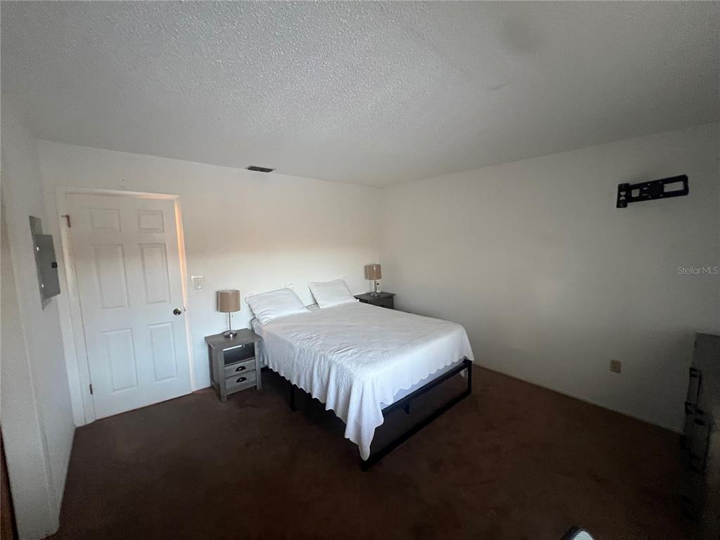 9980 Eagles Point Circle, Unit 3 Port Richey, FL 34668 - Photo 7 of 23 a bedroom with a bed and dresser