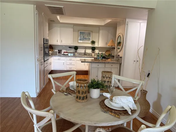a kitchen with granite countertop kitchen island stainless steel appliances a sink and a stove
