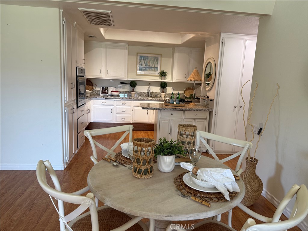 1330 Kenwood Rd M7-157f Seal Beach, CA 90740 - Photo 11 of 44 a kitchen with granite countertop kitchen island stainless steel appliances a sink and a stove