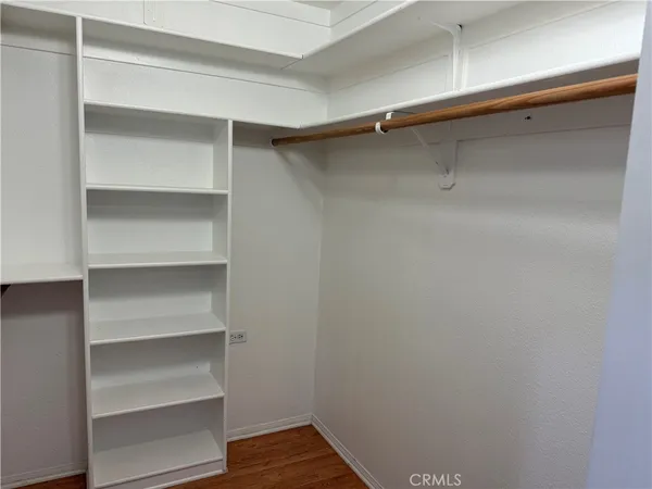 a view of walk in closet with empty racks