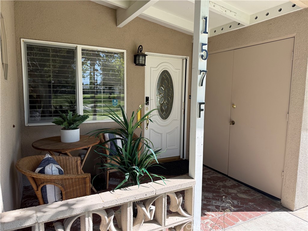 1330 Kenwood Rd M7-157f Seal Beach, CA 90740 - Photo 2 of 44 a view of a hallway with wooden floor and a potted plant