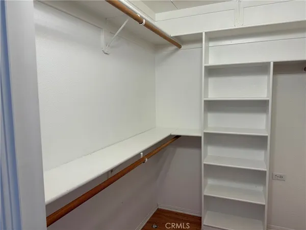 a view of walk in closet with empty racks