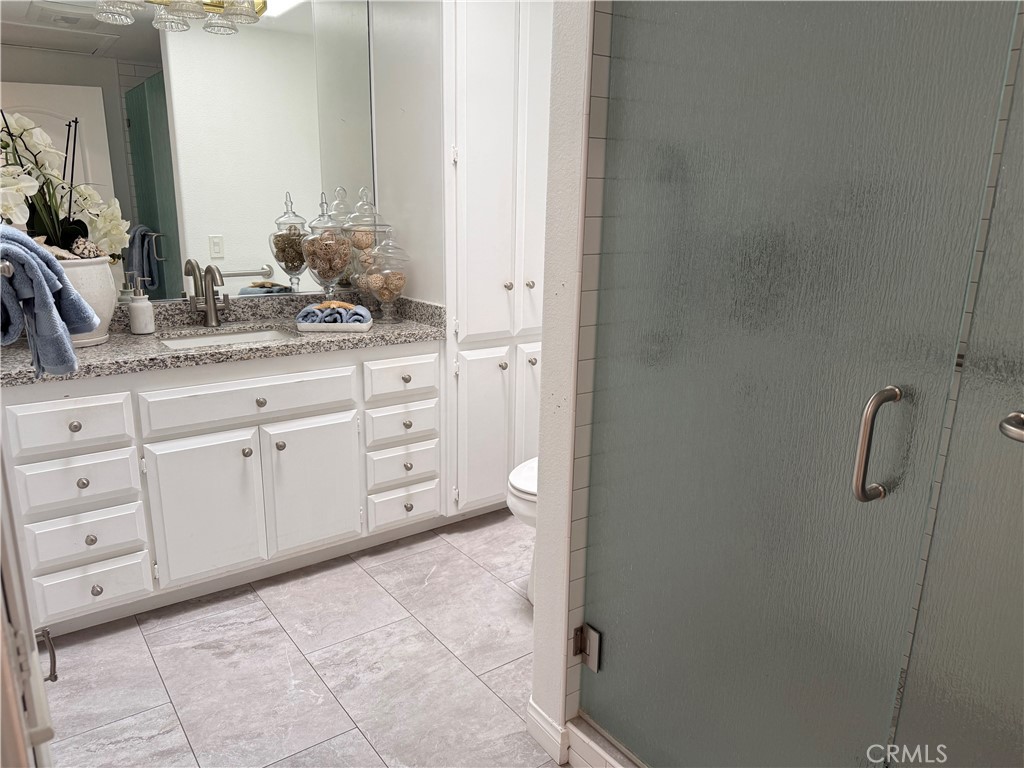 1330 Kenwood Rd M7-157f Seal Beach, CA 90740 - Photo 33 of 44 a bathroom with a granite countertop sink and a mirror