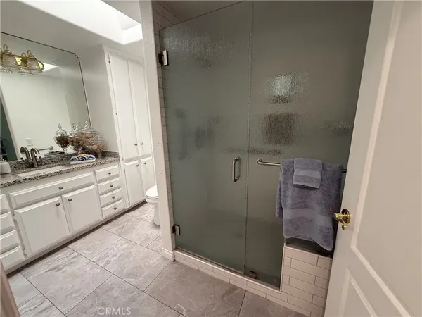 a bathroom with a shower and a sink