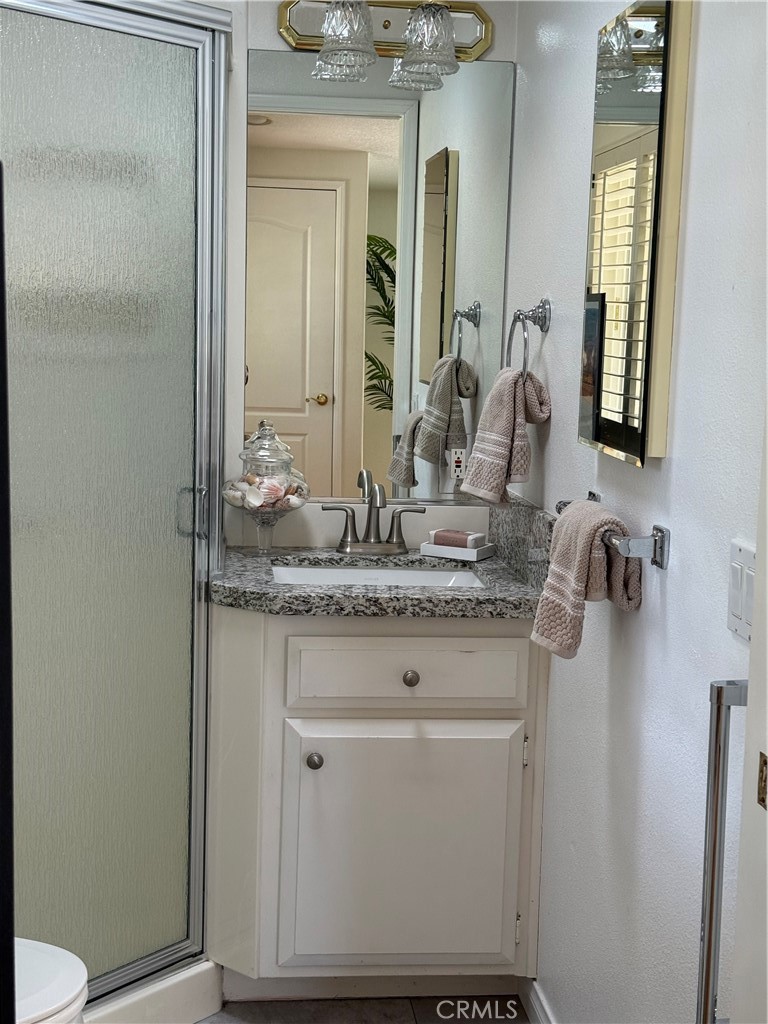 1330 Kenwood Rd M7-157f Seal Beach, CA 90740 - Photo 41 of 44 a bathroom with a granite countertop sink and a mirror