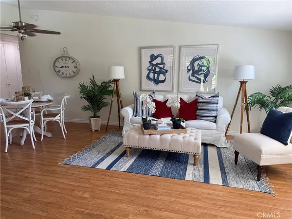 a living room with furniture or wooden floor and a rug