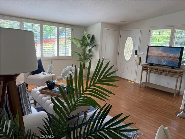 a view of a livingroom with furniture window and wooden floor