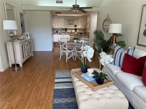 a living room with furniture a rug and a lamp