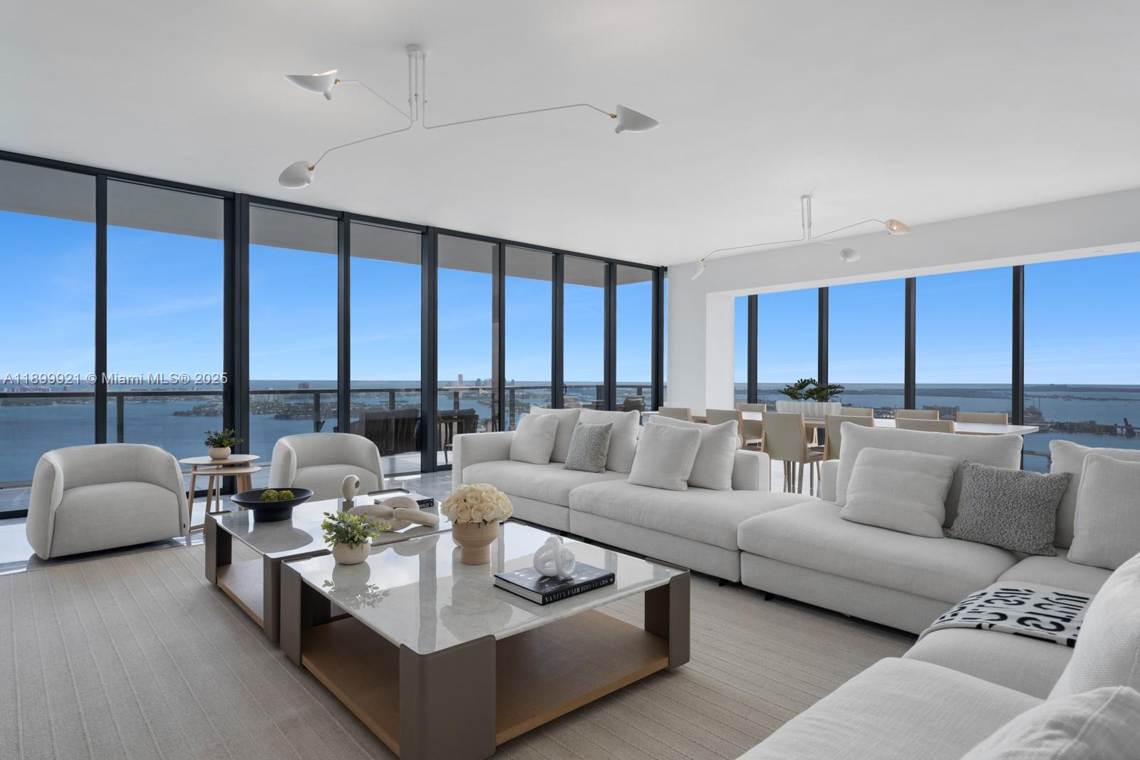a living room with furniture and large windows